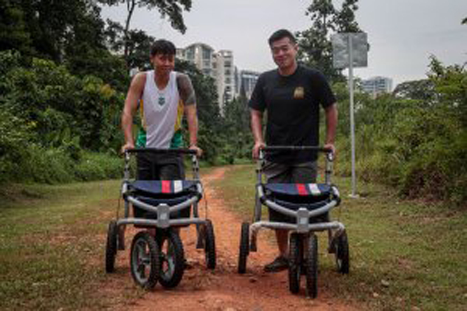 two brothers with walking devices on a path