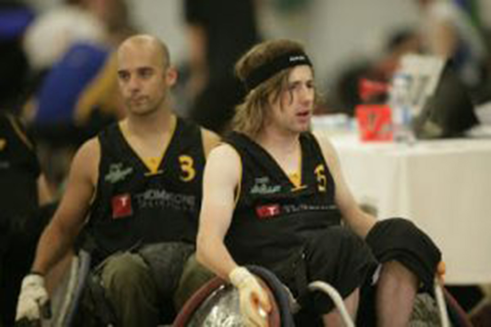 two men in wheelchair rugby chairs