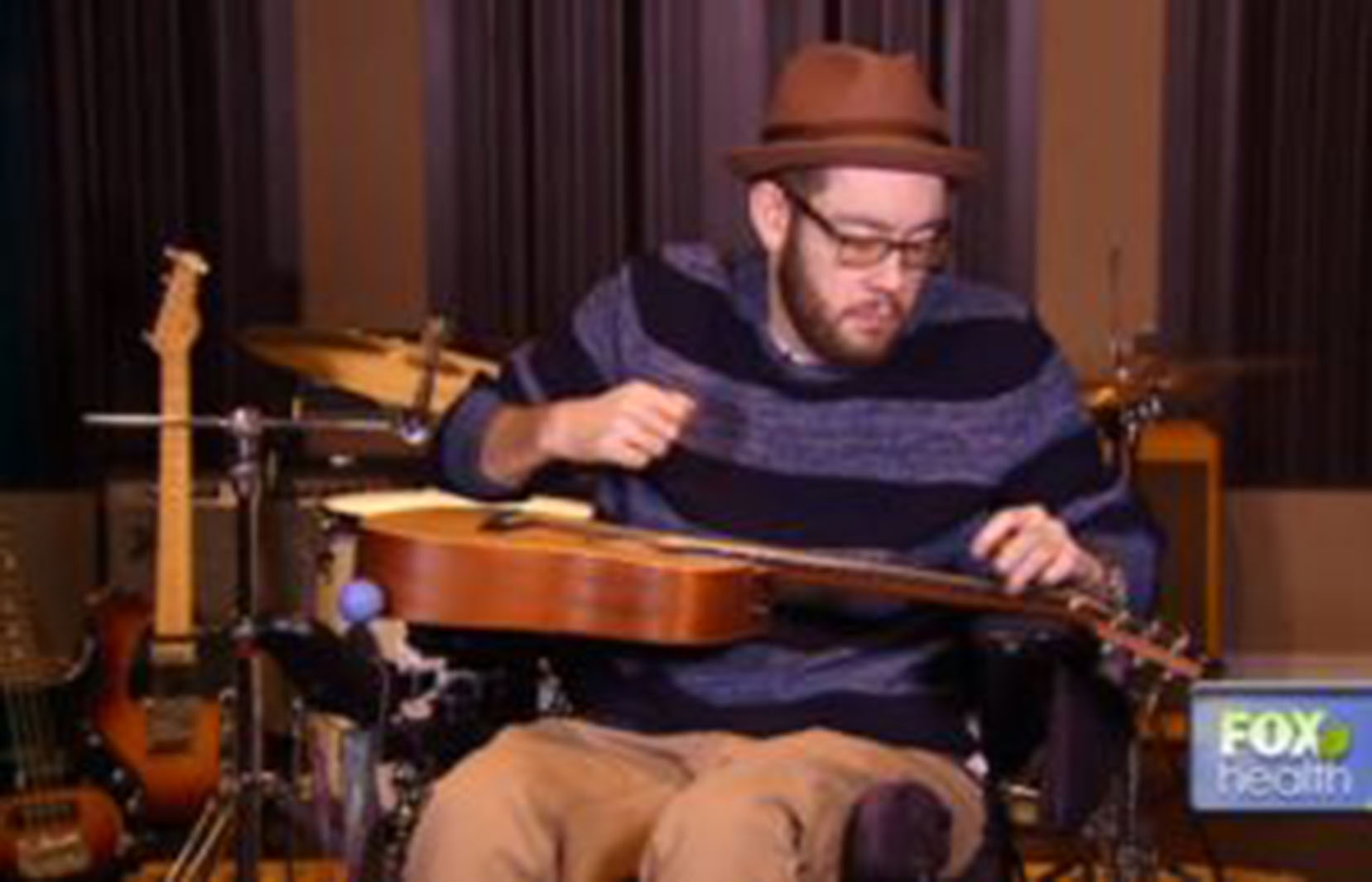 quadriplegic man playing a guitar