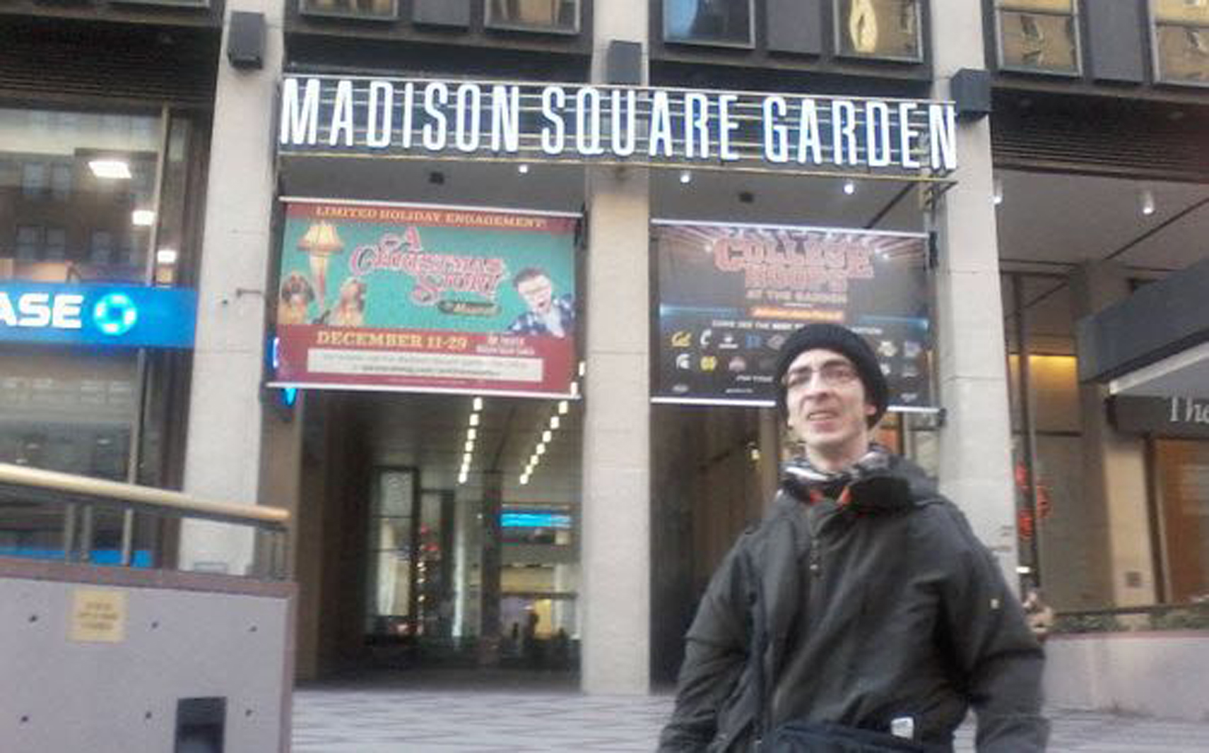man standing in front of madison square garden in NYC