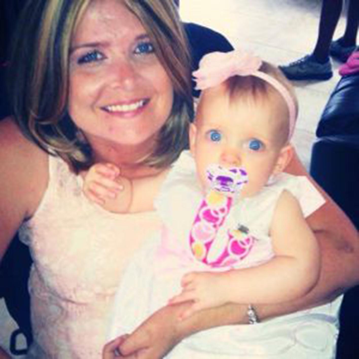 Quadriplegic mom holding her baby and smiling