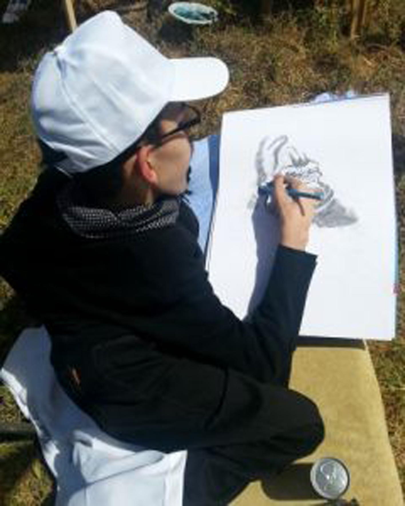 man drawing on paper