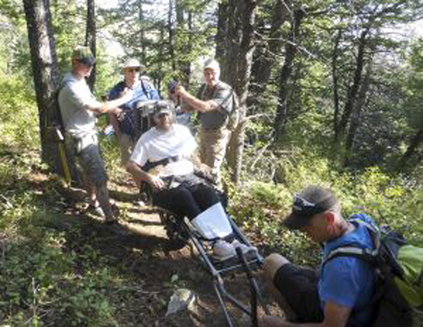 paralyzed person in a modified wheelchair on a trail