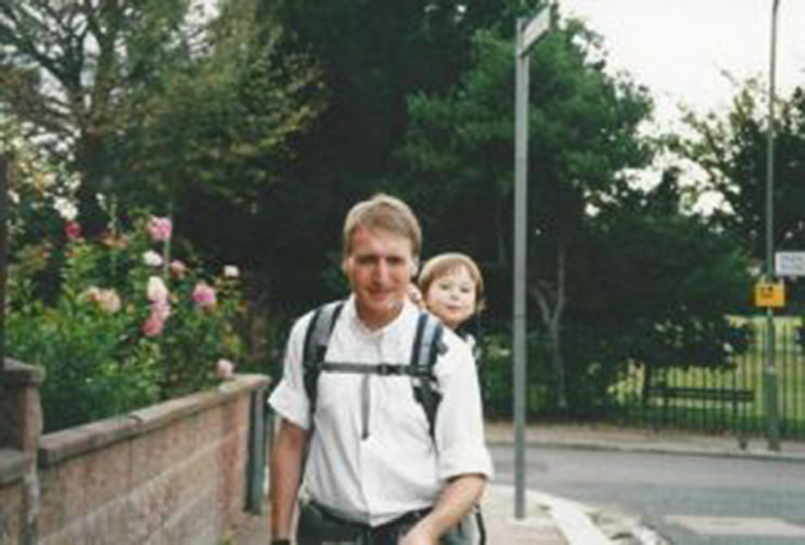 a man with his little daughter riding on his back
