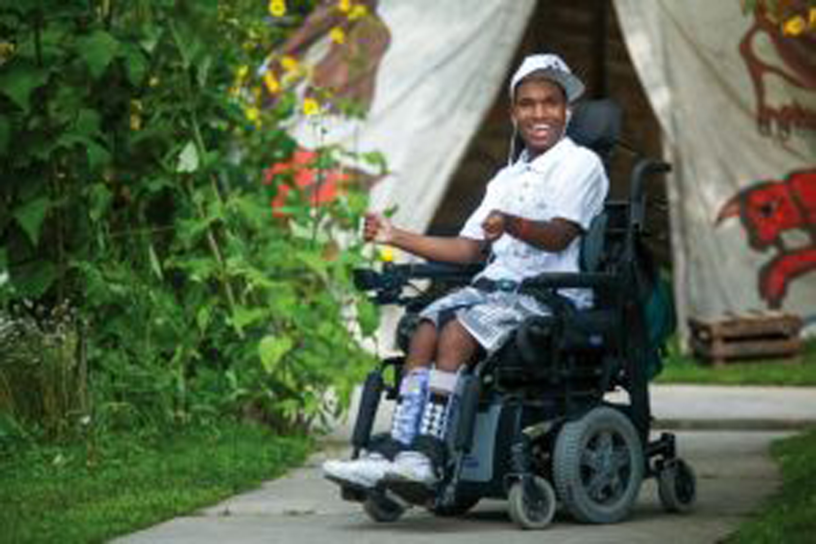 a man in a power wheelchair smiling