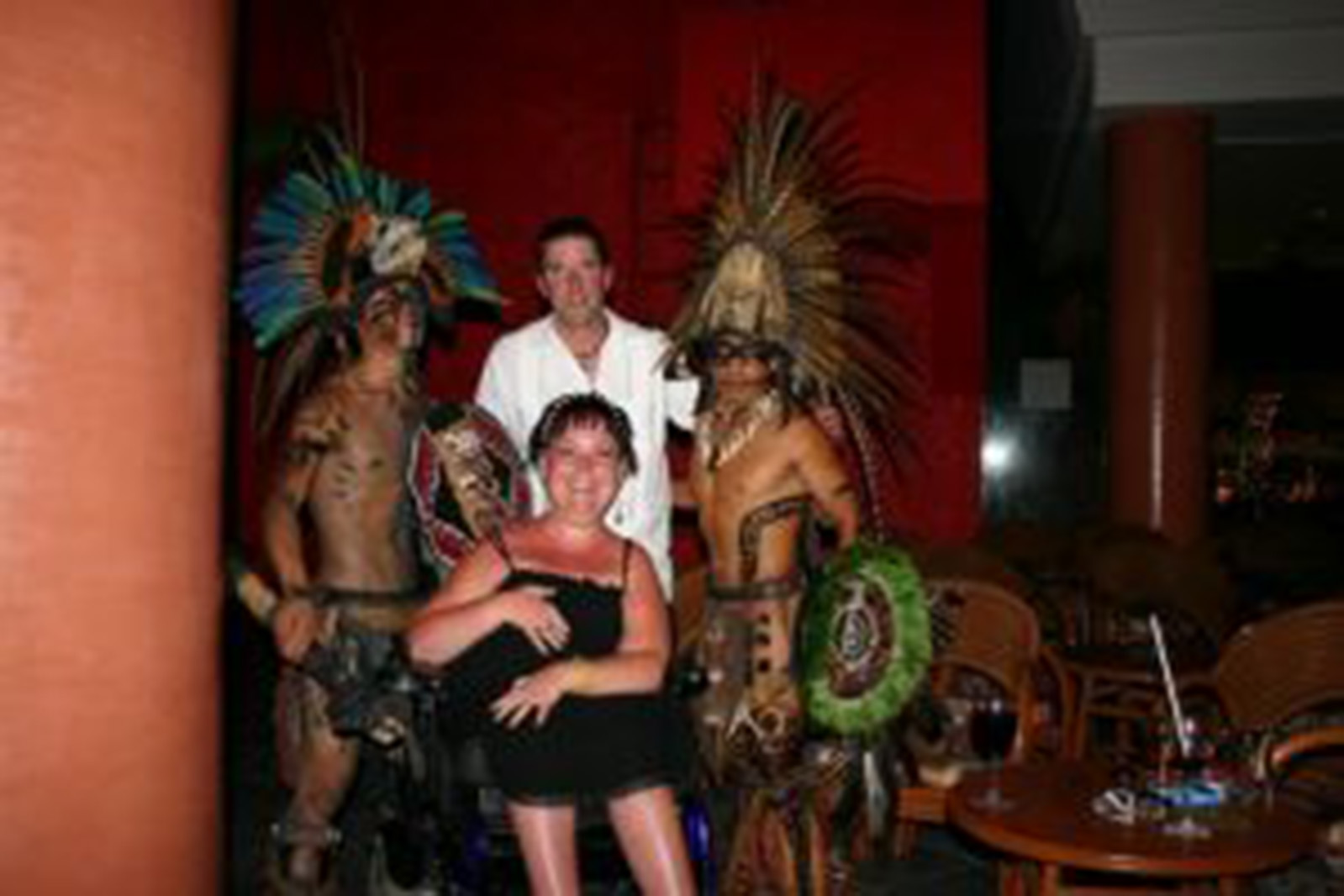 woman in power wheelchair and her husband posing with two people in costume