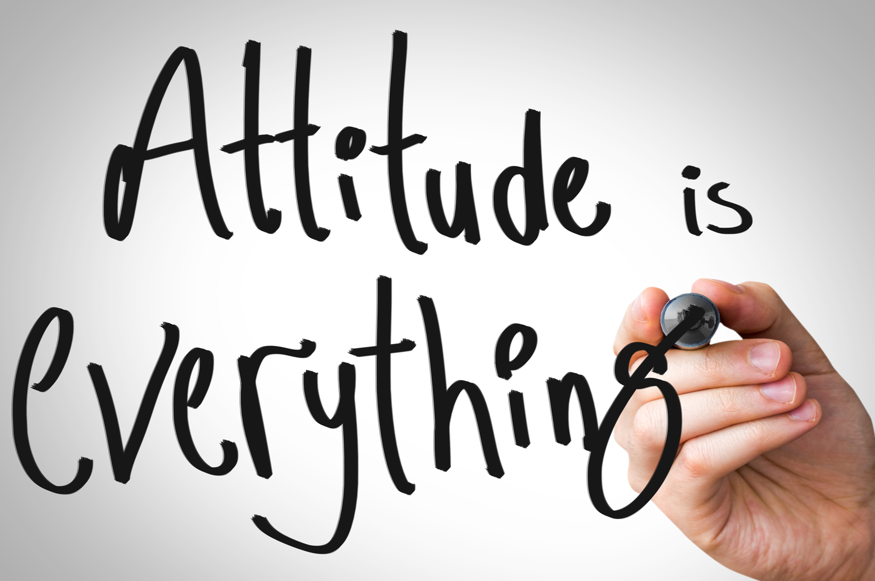 Handwritten text on screen "Attitude is everything"