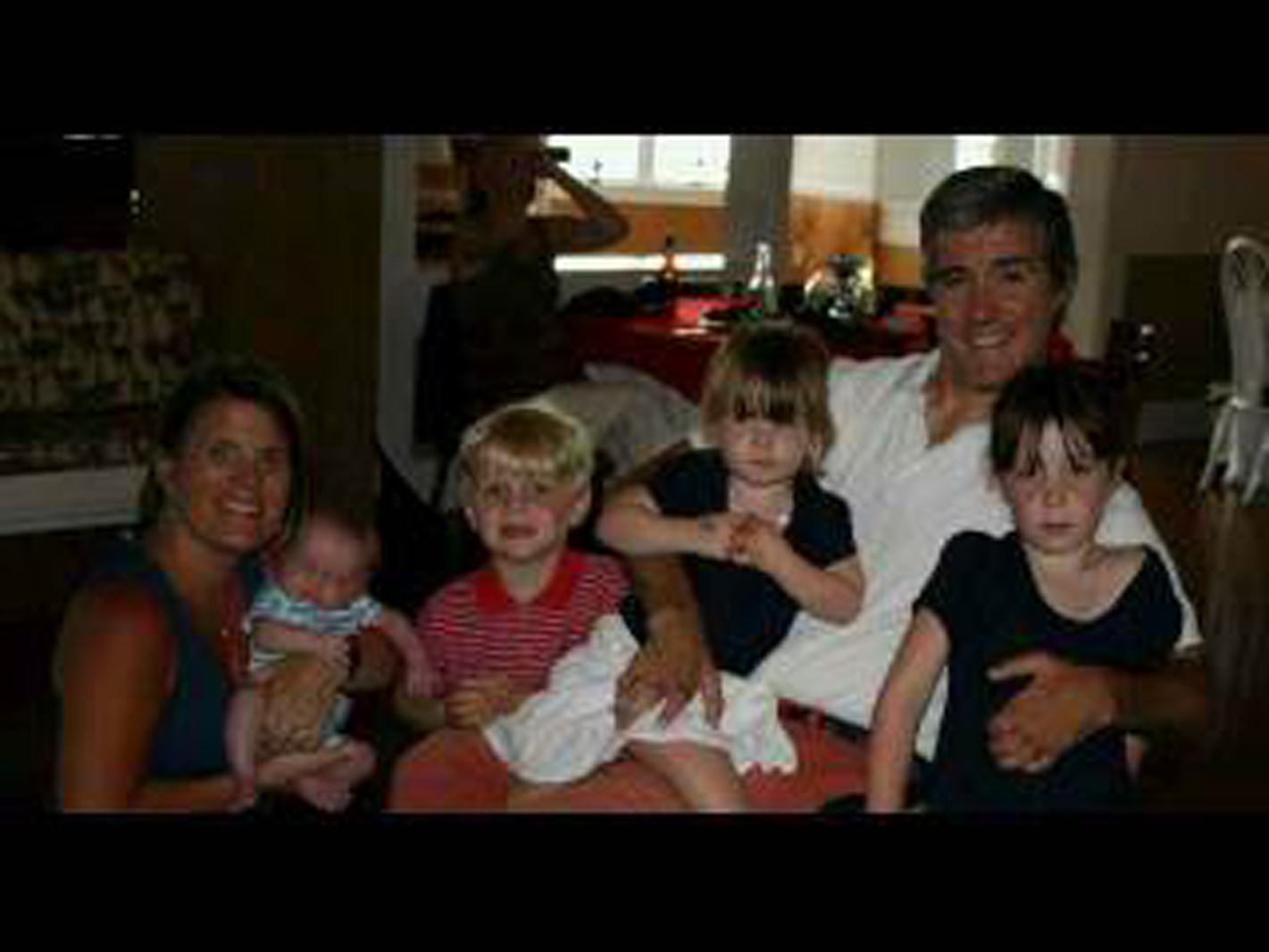 Quadriplegic dad, his wife and 4 kids smiling