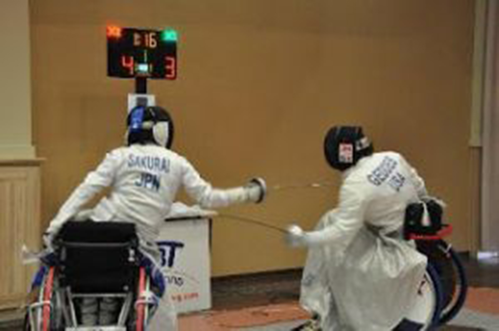 two people fencing in wheelchairs 