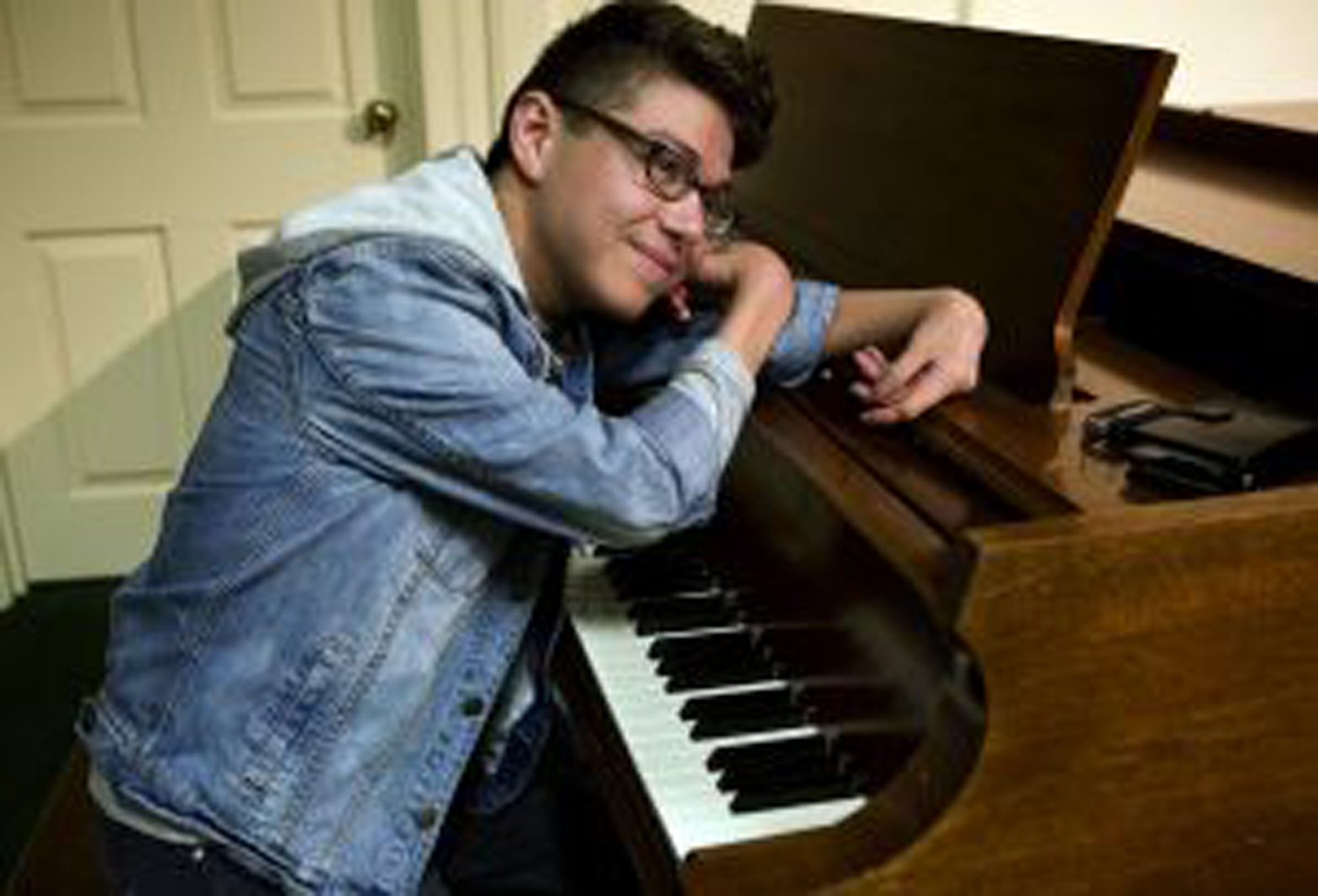 a man leaning over a piano