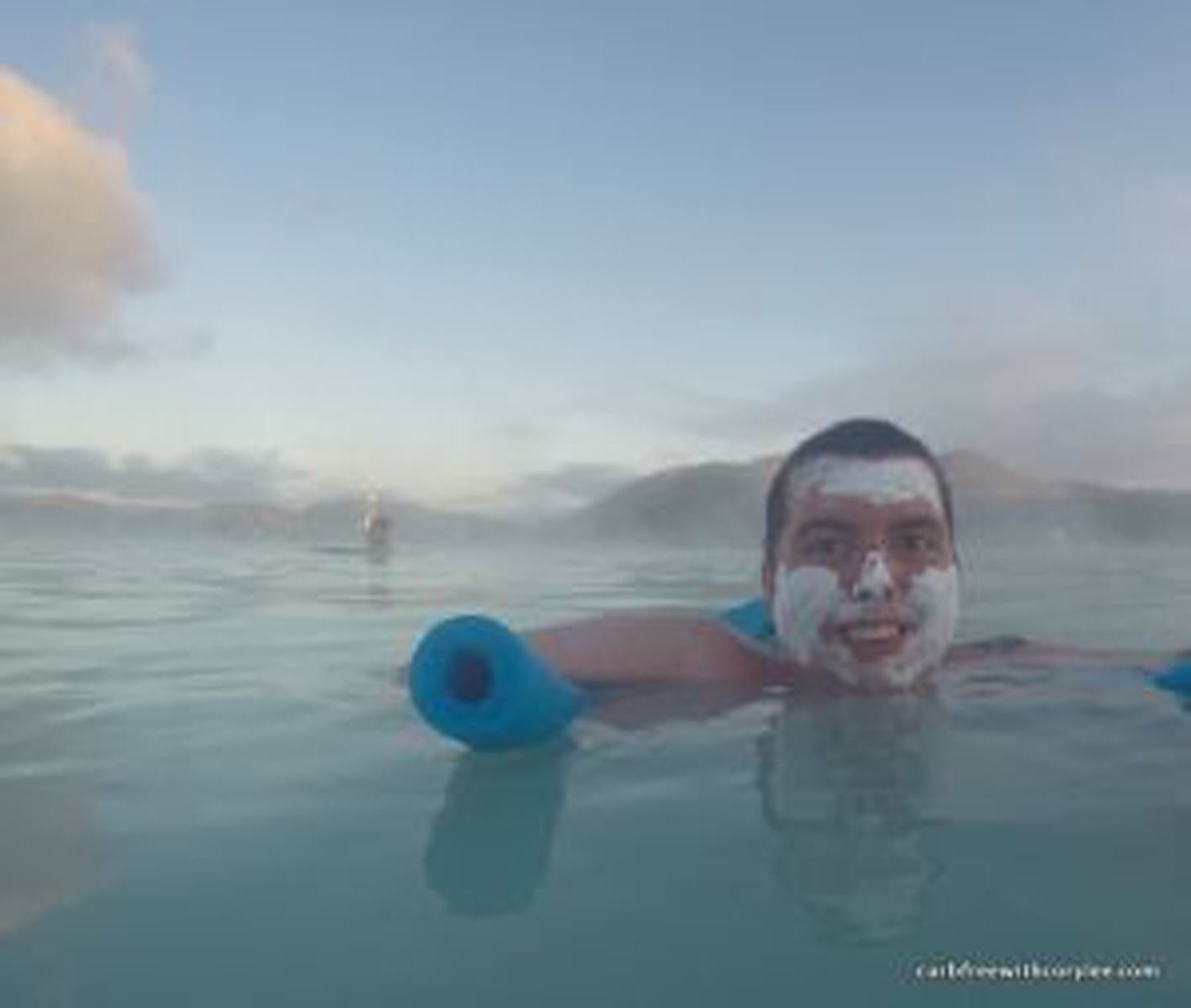 a man floating on a pool noodle in the Blue Lagoon