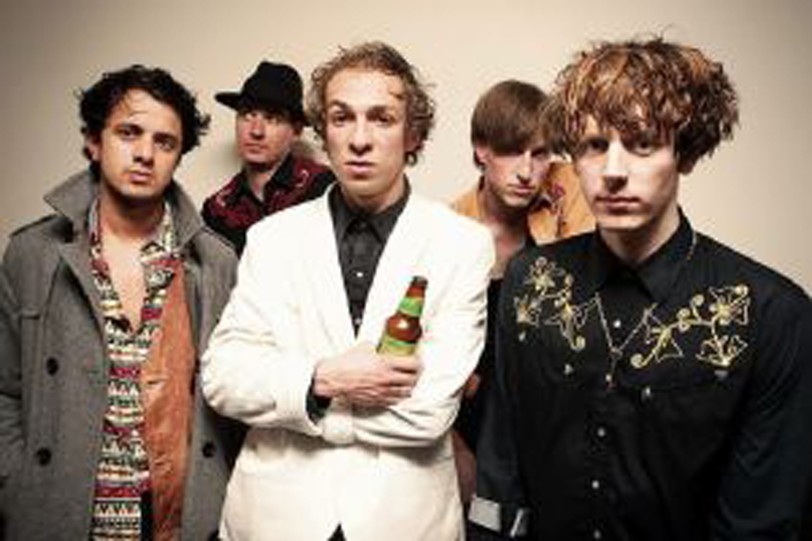 5 men of a music group standing together