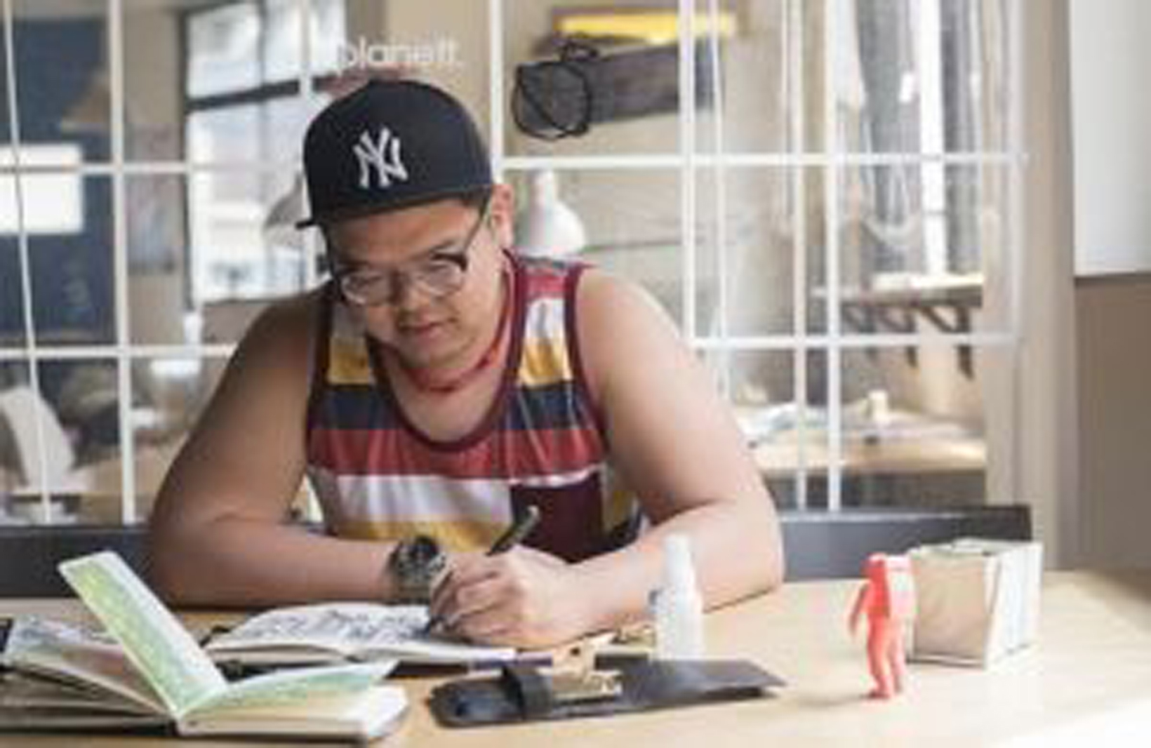 man drawing at a table