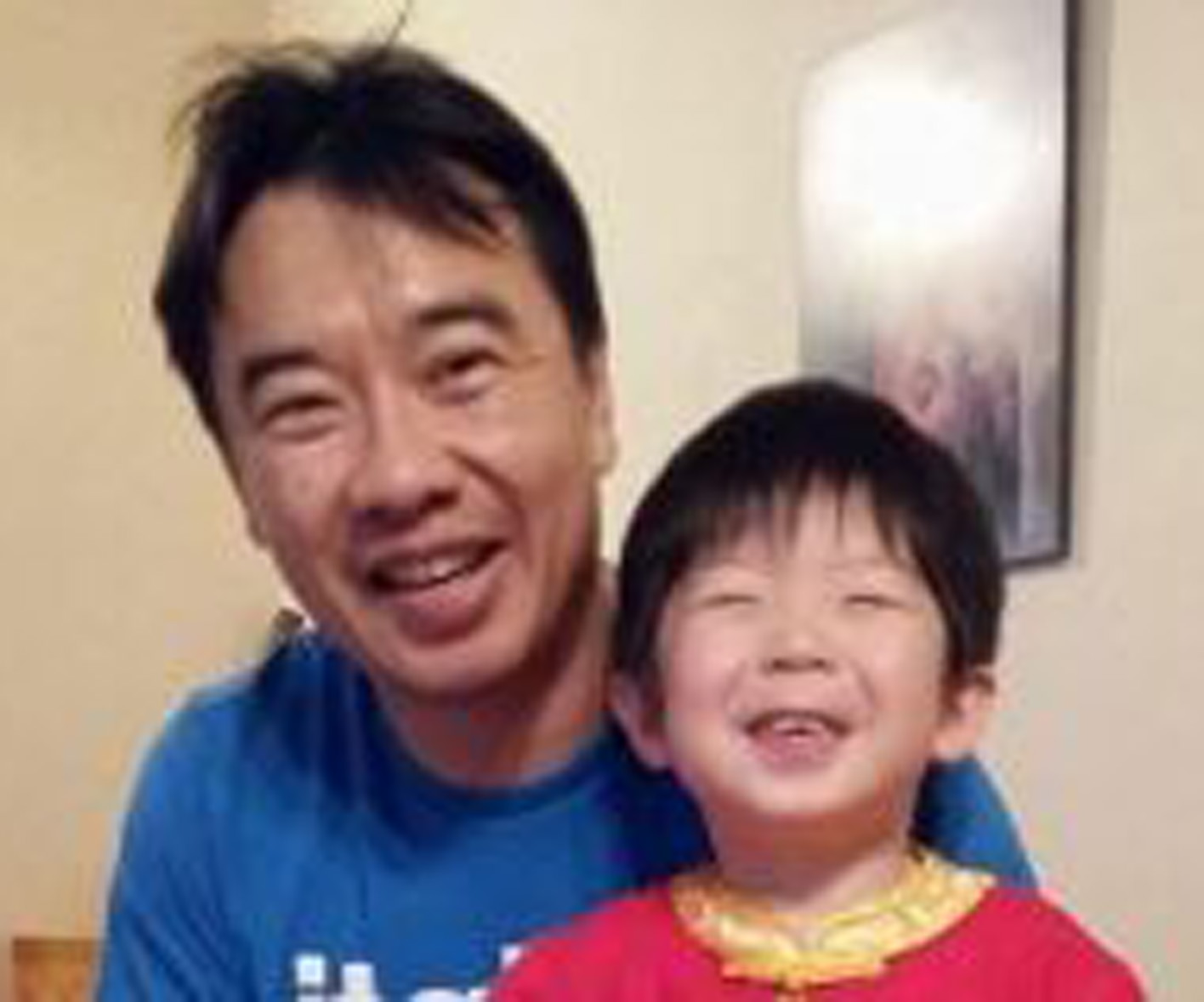 a man smiling with his son