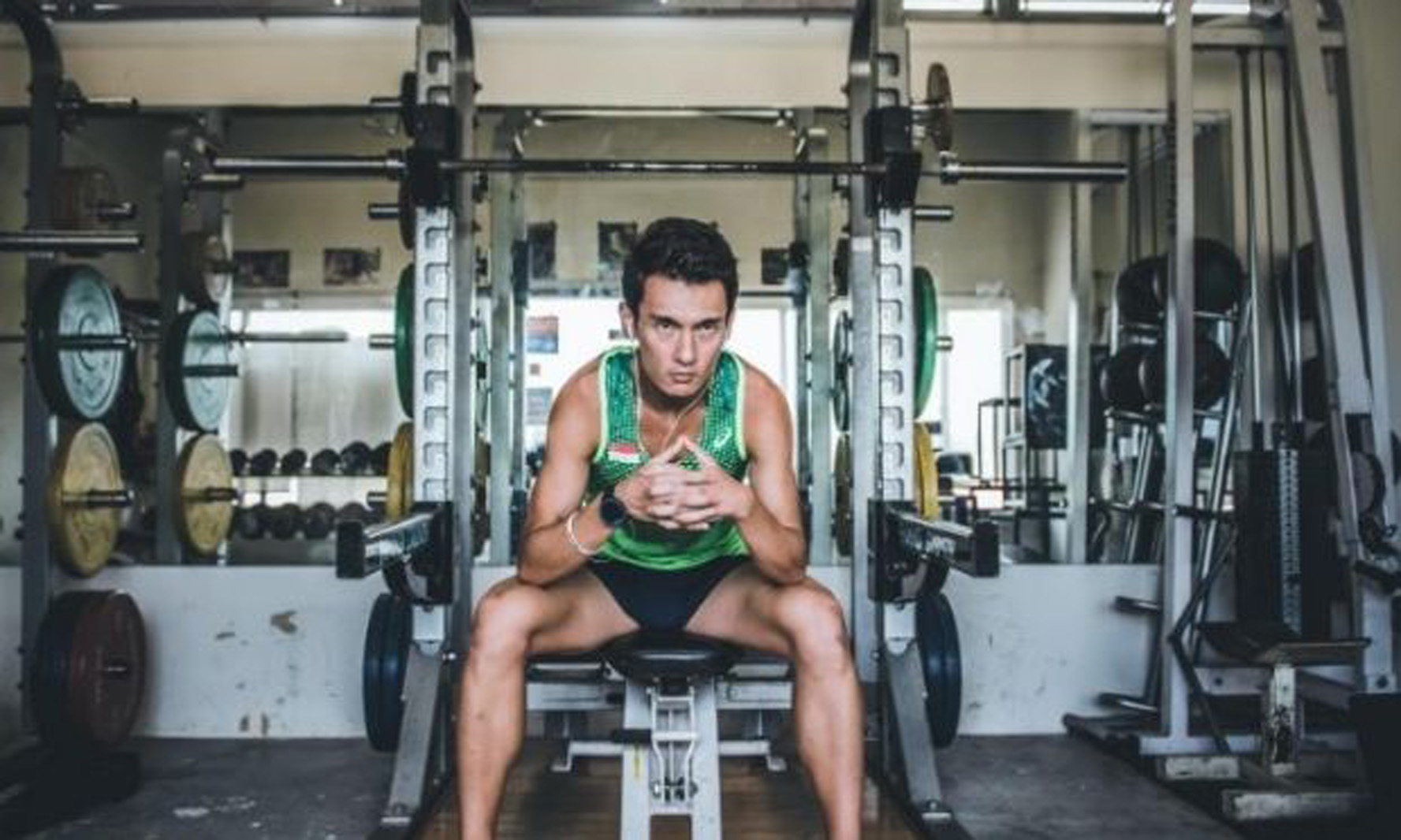 man sitting on exercise equipment
