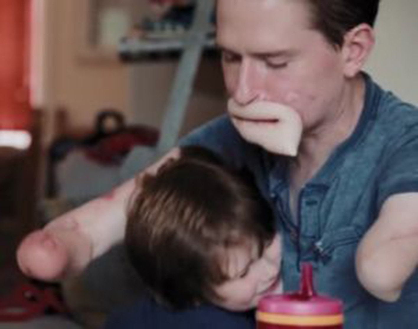 man plays with his young child