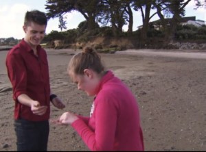 Brother and sister looking at something on the beach