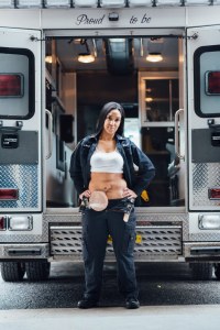 woman standing in front of an ambulance with an ostomy bag visible
