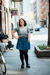 a woman standing and smiling