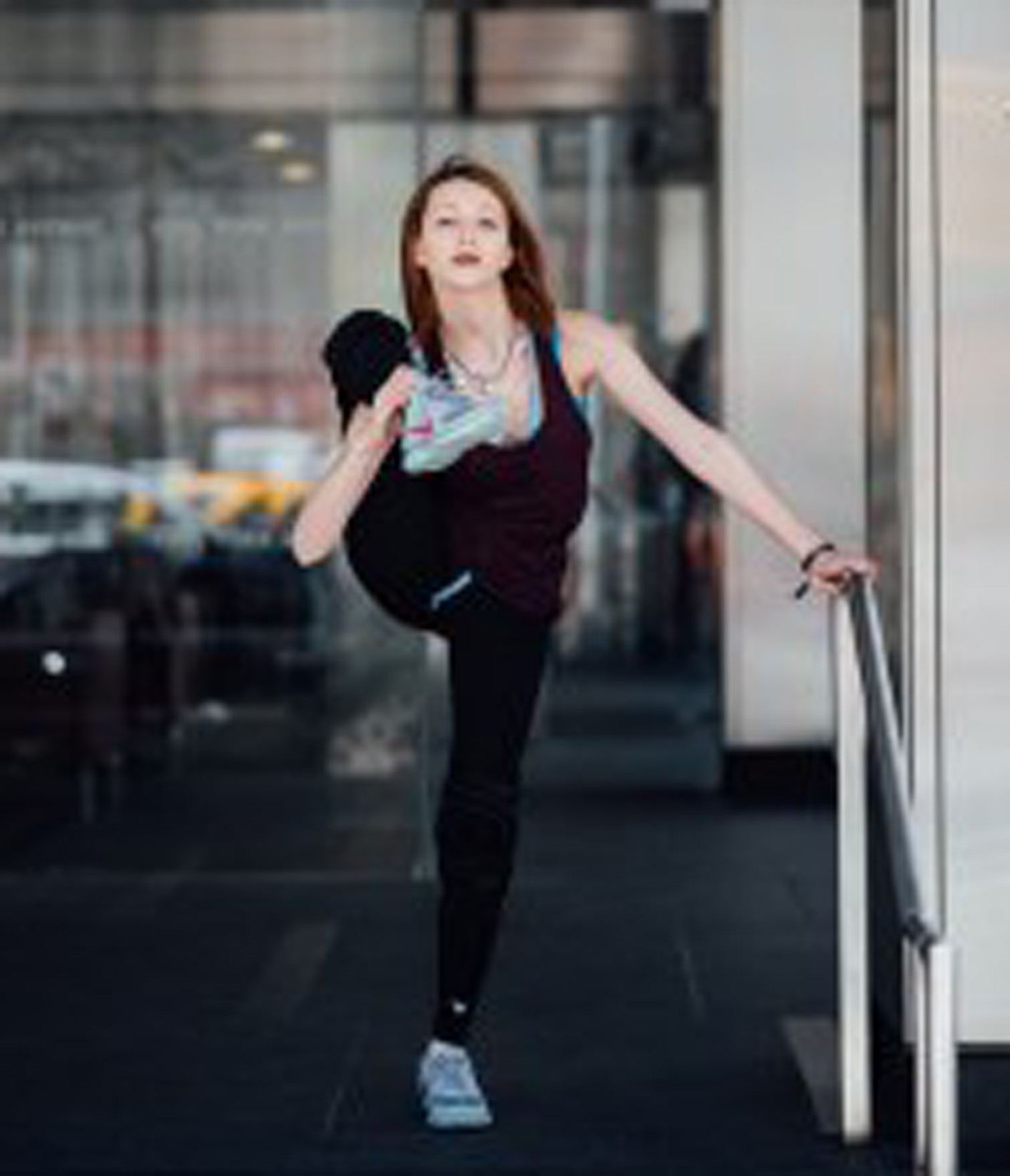 a woman stretching her leg up over her shoulder