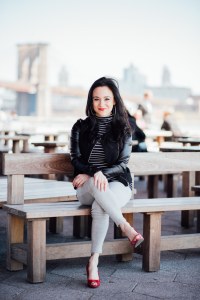 a woman sitting on a bench smiling