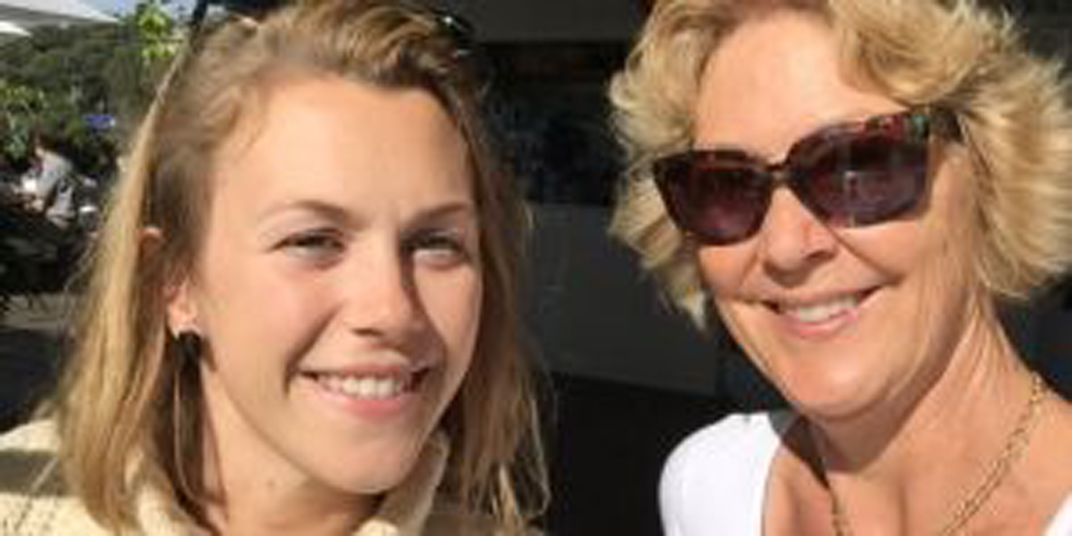 a mom and daughter smiling