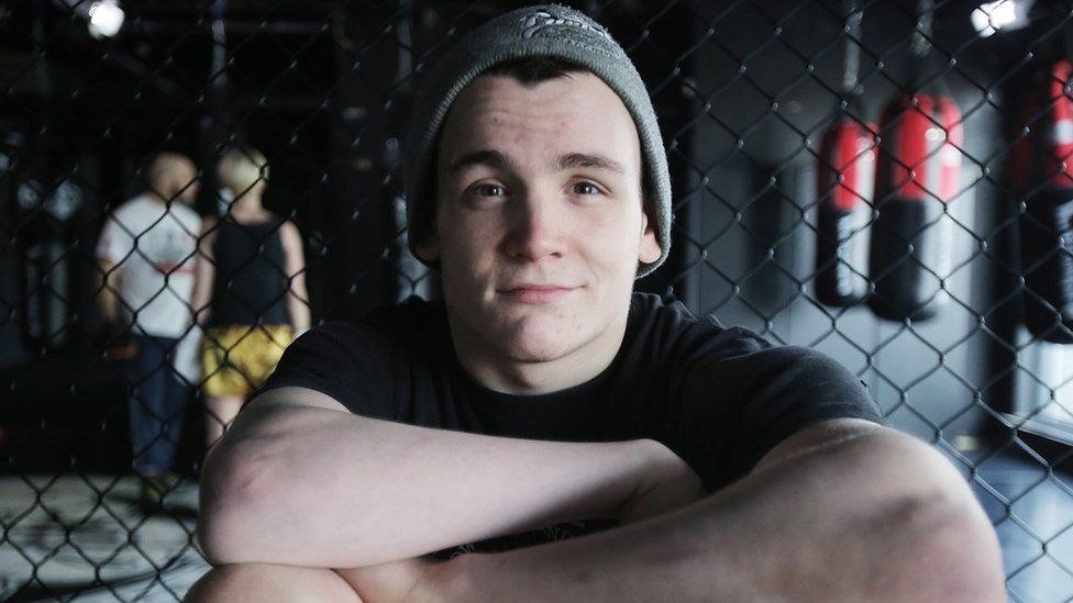 a man smiling with his arms crossed