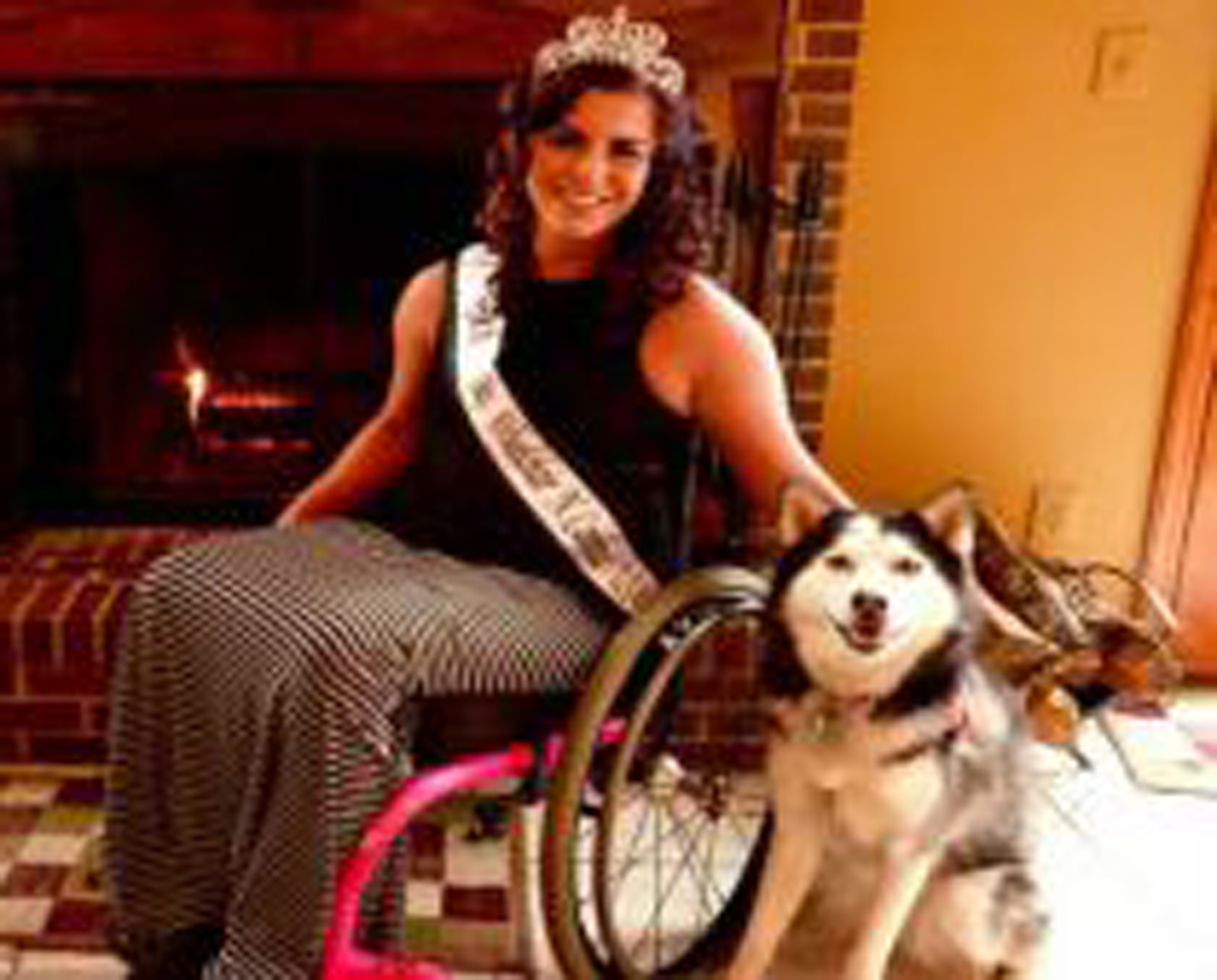 a woman in a manual wheelchair with her dog