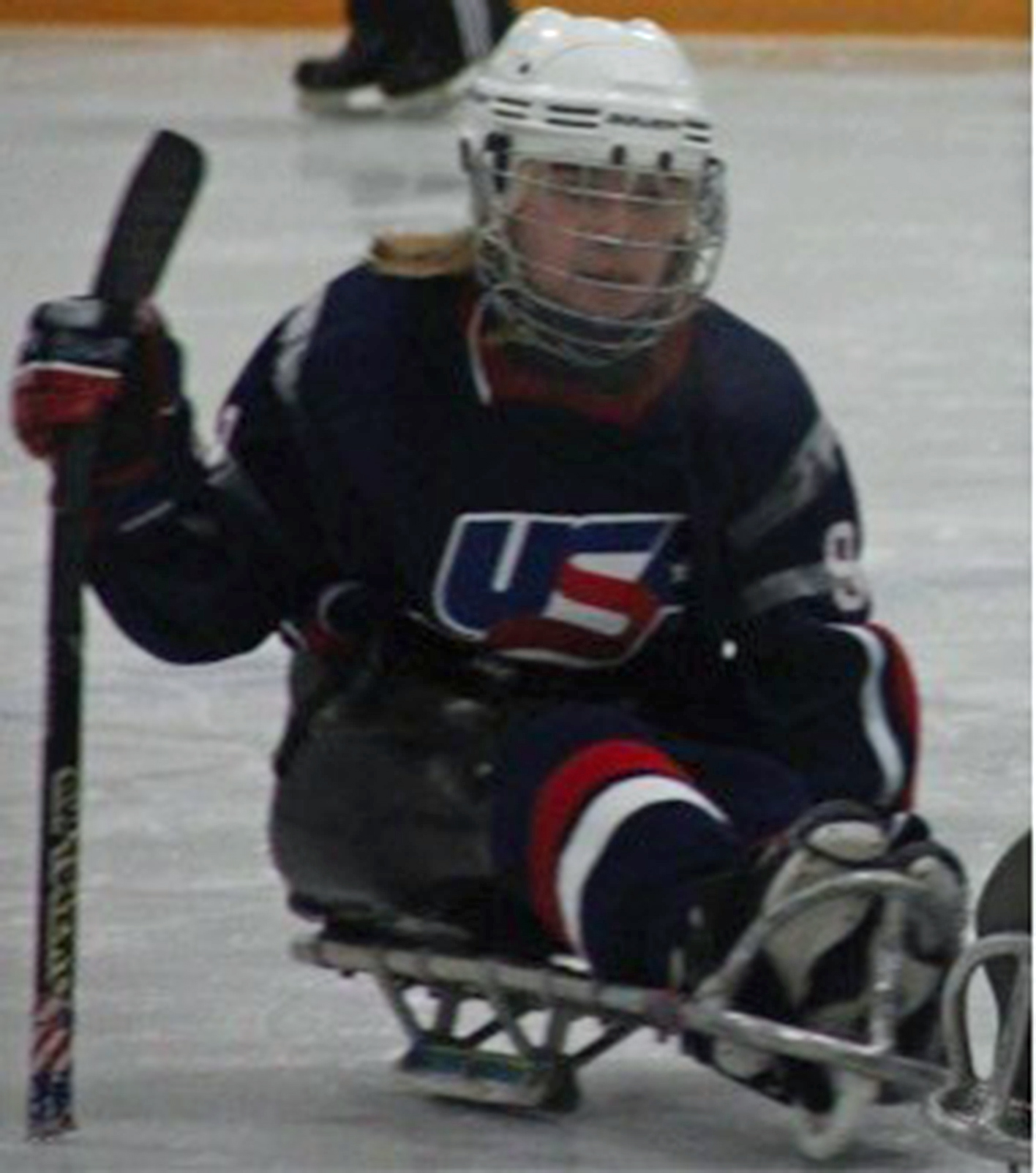 woman playing sled hockey