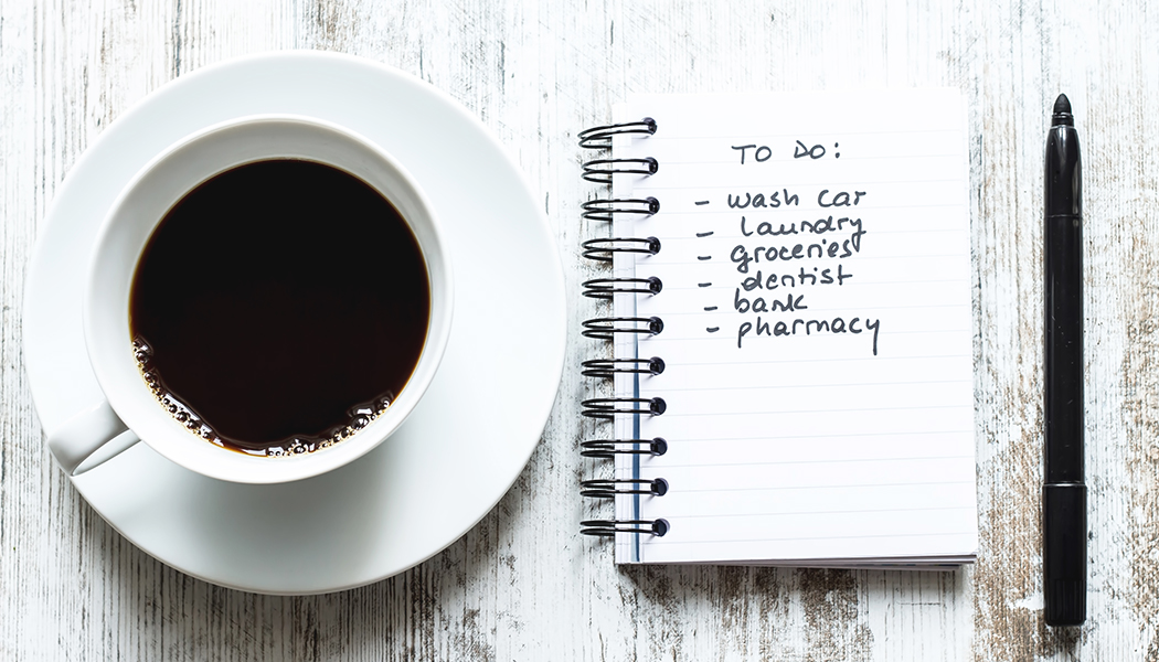 cup of coffee, to do list, and pen sit on a table