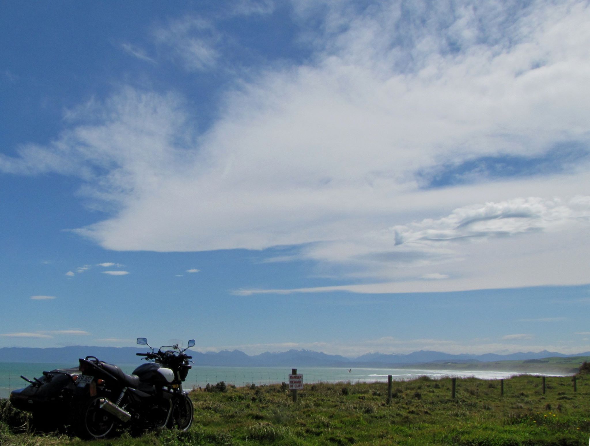 motorcycle with ocean and sky in the background