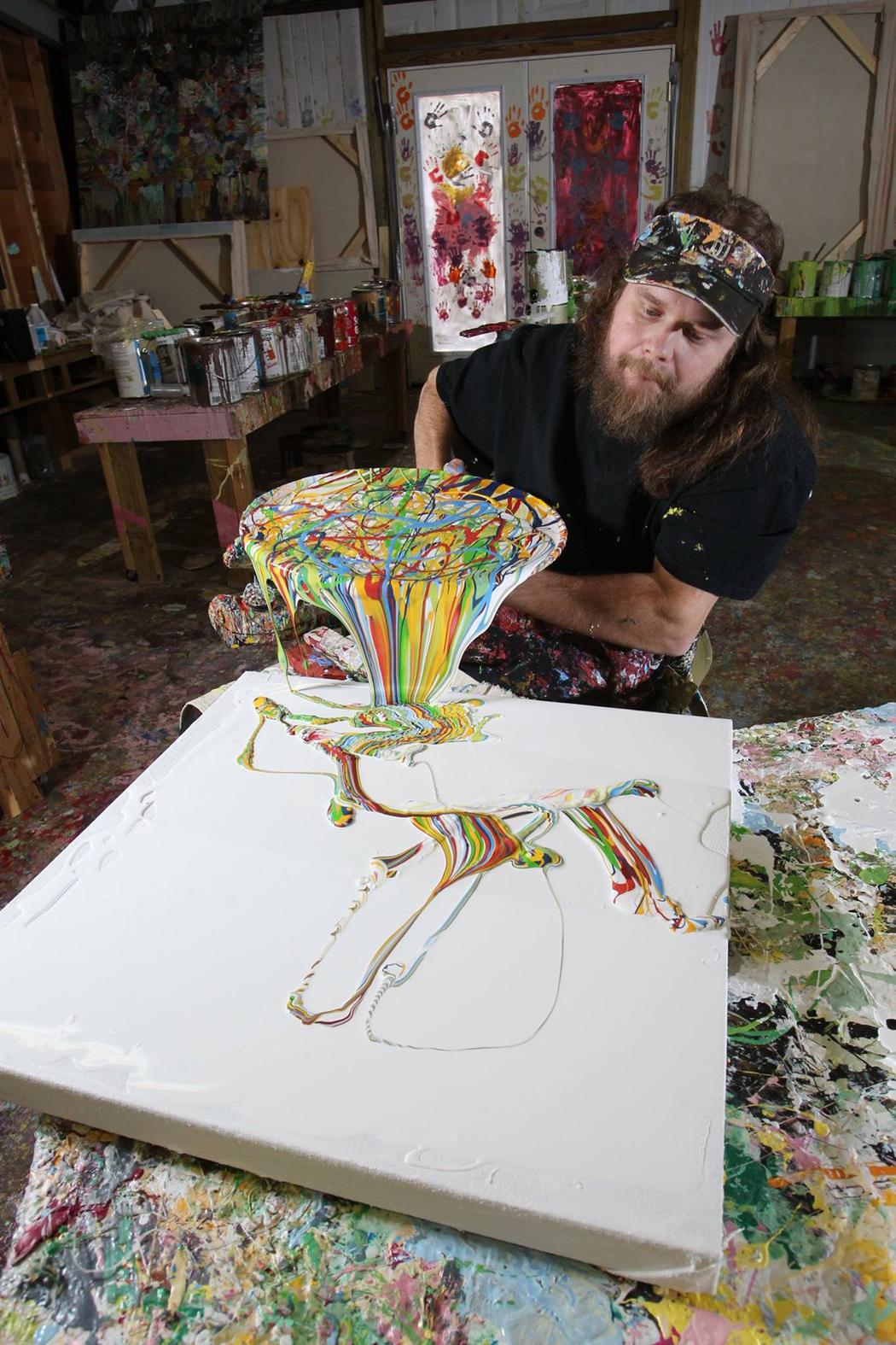 quadriplegic artist demonstrates drip painting