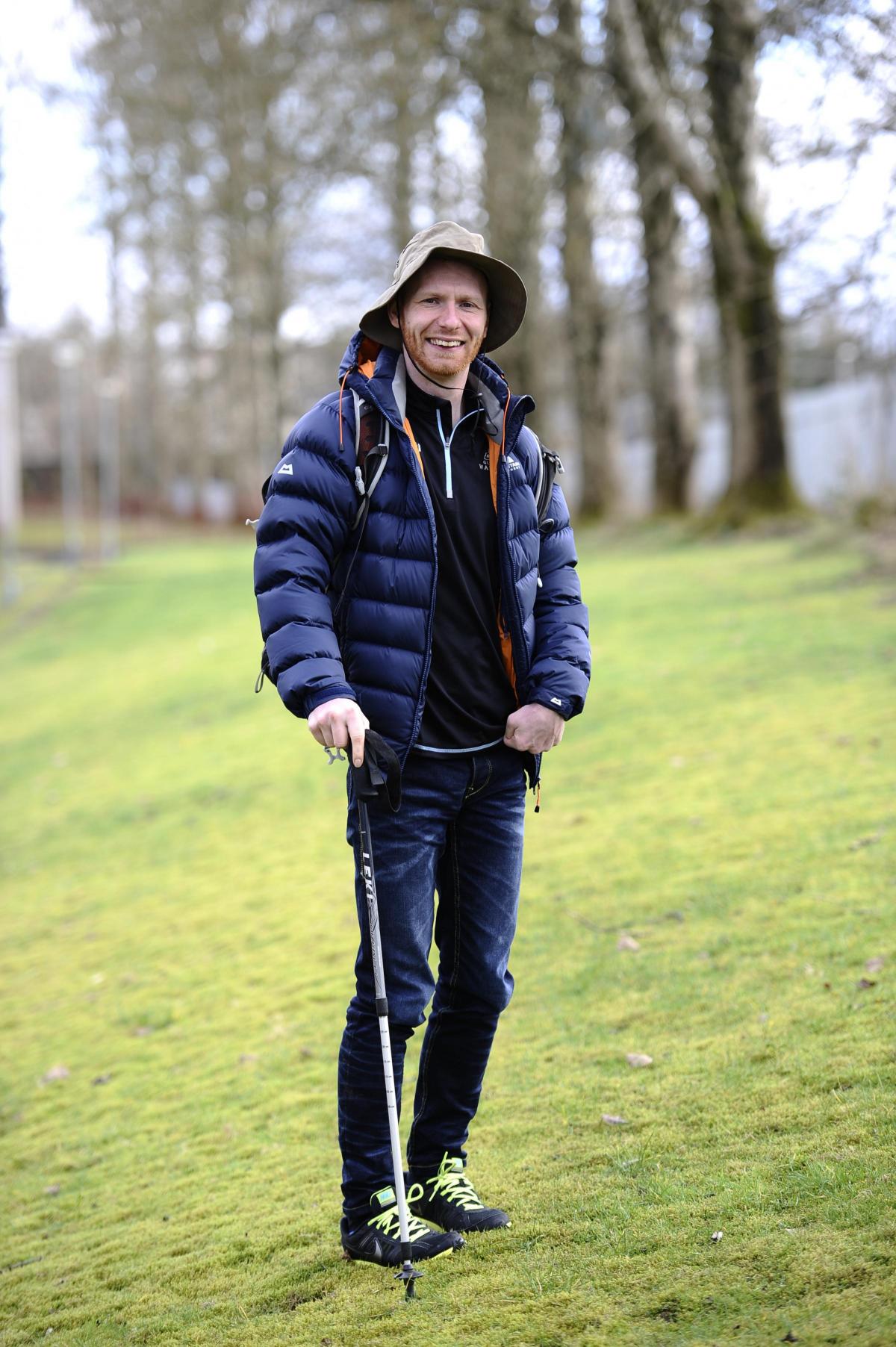 man with cerebral palsy holds a cane for support