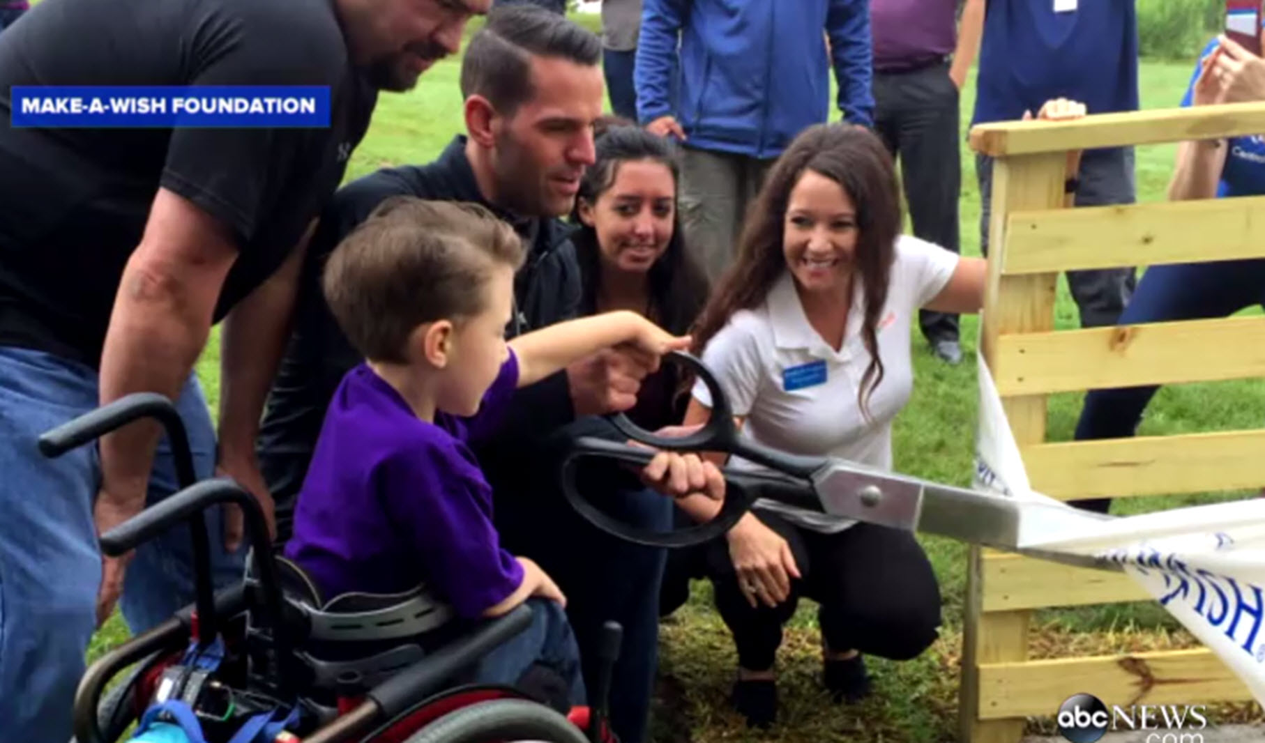 boy with cerebral palsy and spina bifida cuts ribbon to accessible treehouse