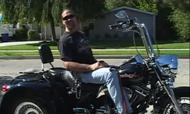paraplegic man sits atop a modified trike