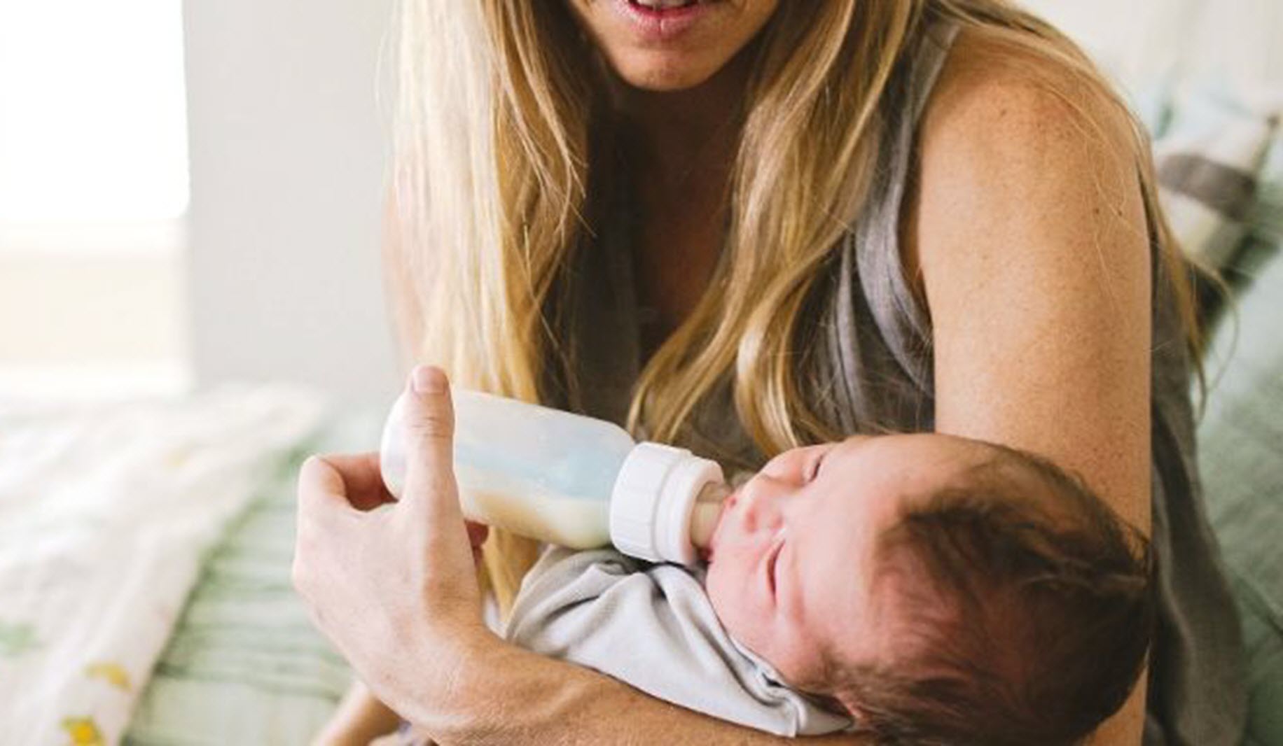 mom feeds baby a bottle