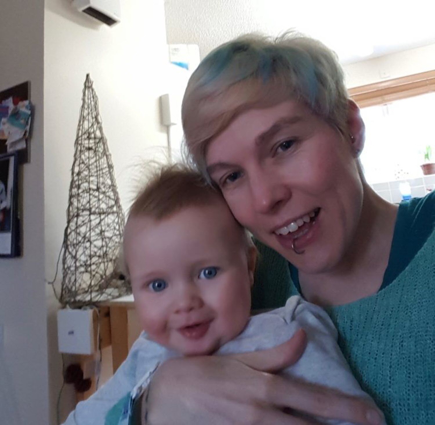 mom with sma holds her baby son