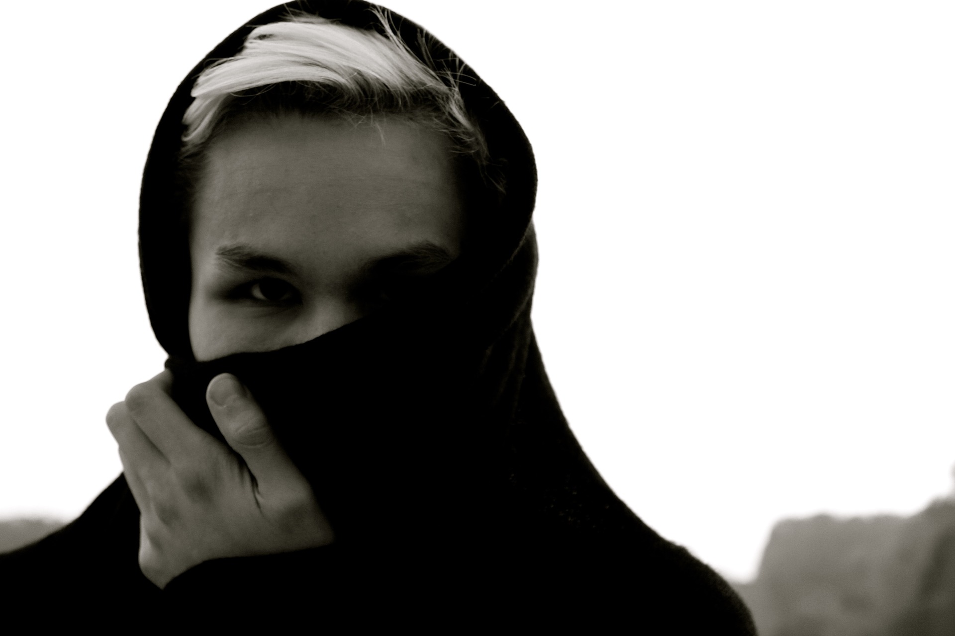 individual with partially concealed face