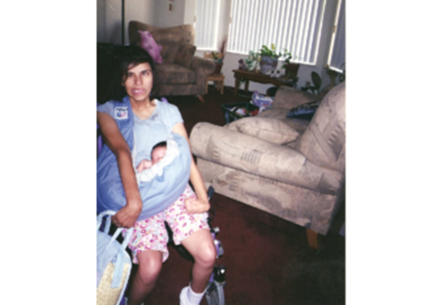 mom with cerebral palsy holds her newborn son