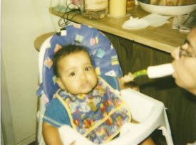 mom with cp feeds her son by holding a spoon in her mouth