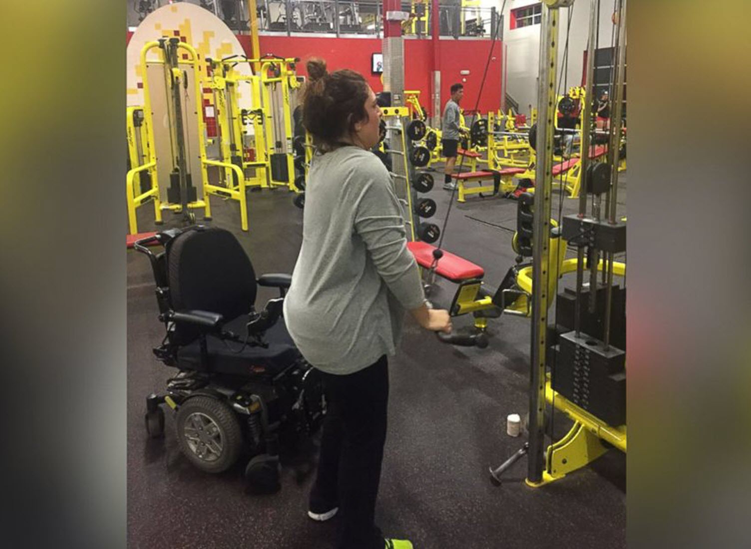 paralyzed woman works out in a gym
