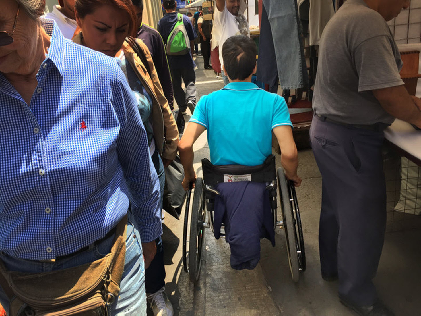 wheelchair user navigates a busy street in Mexico