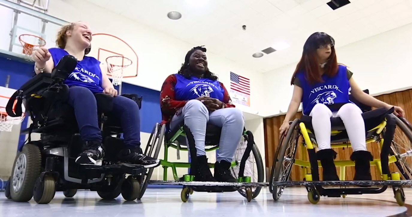 three young women are wheelchair basketball athletes for their school's team