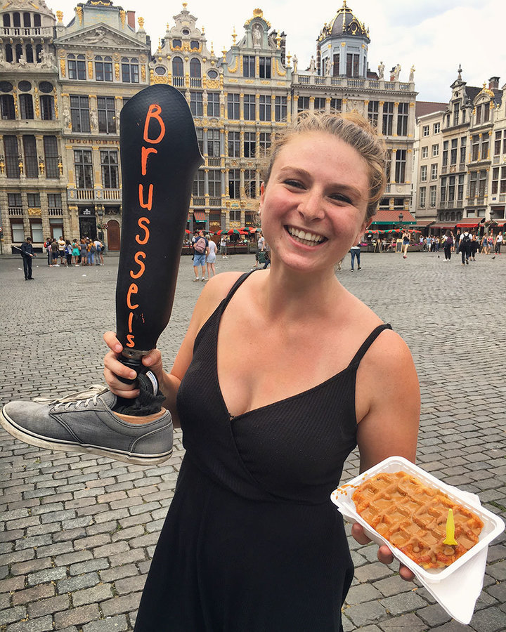 woman documents travels with chalkboard leg