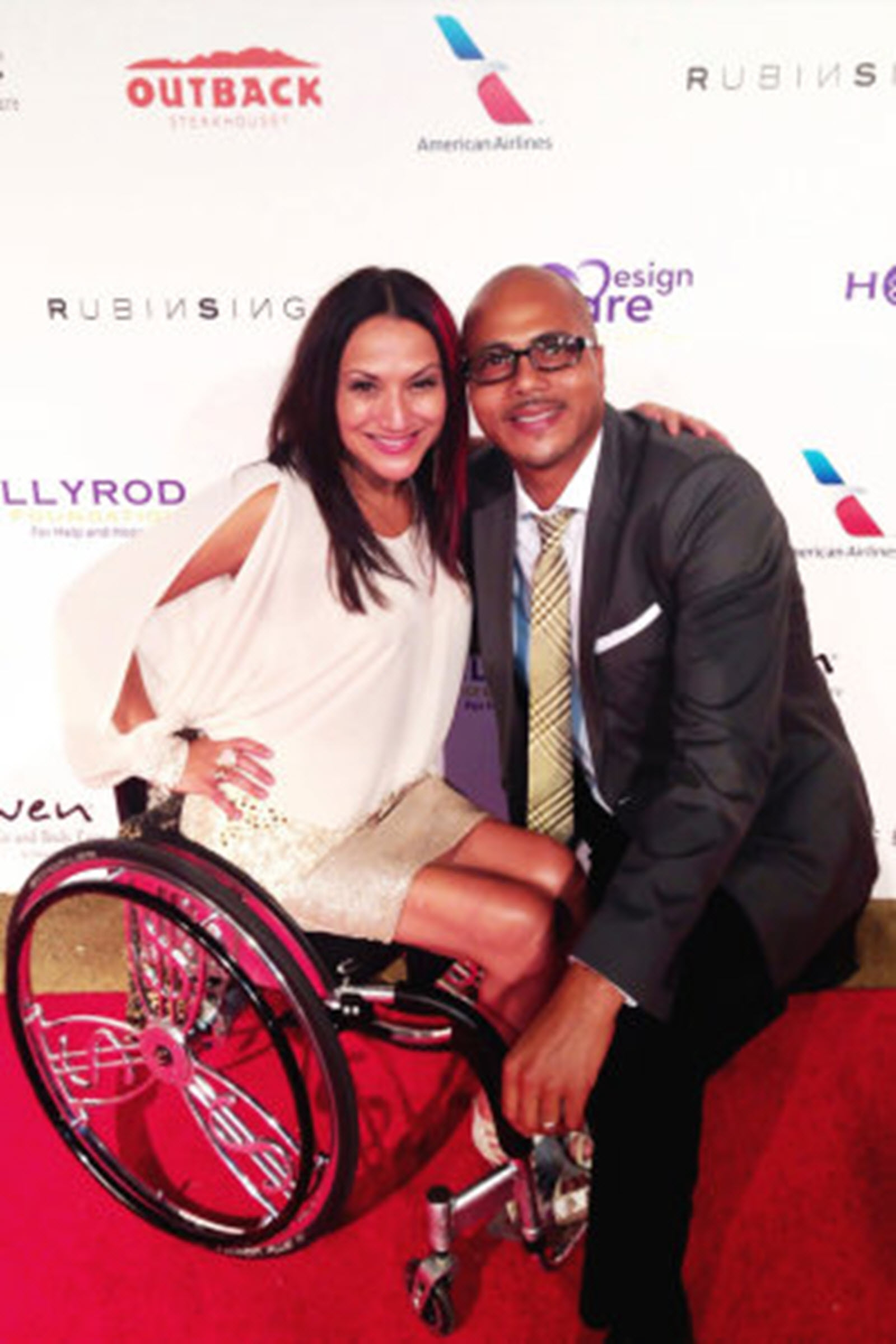 a female wheelchair user poses next to a man