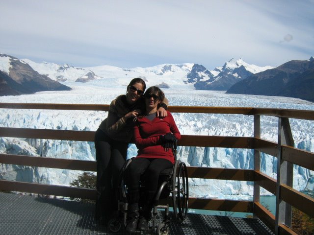 two women post in front of the Perito Moreno glacier in Argentina
