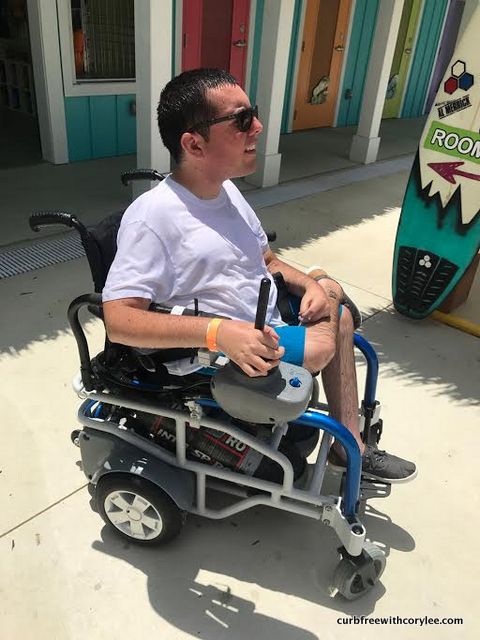 man with sma uses an oxygen-powered wheelchair at an accessible waterpark
