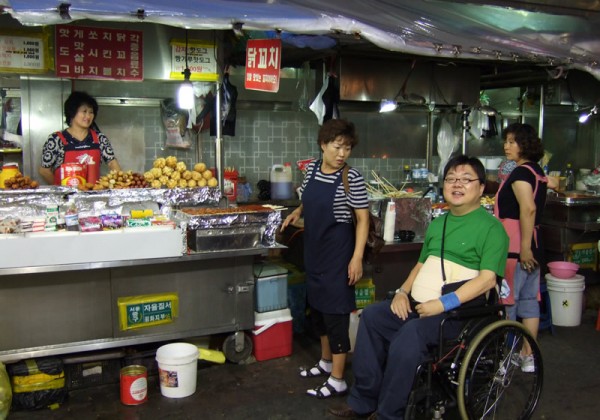 quadriplegic Gilbert Tan at a food market