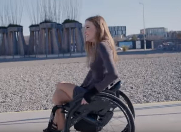 tetraplegic wheels on a boardwalk at the beach