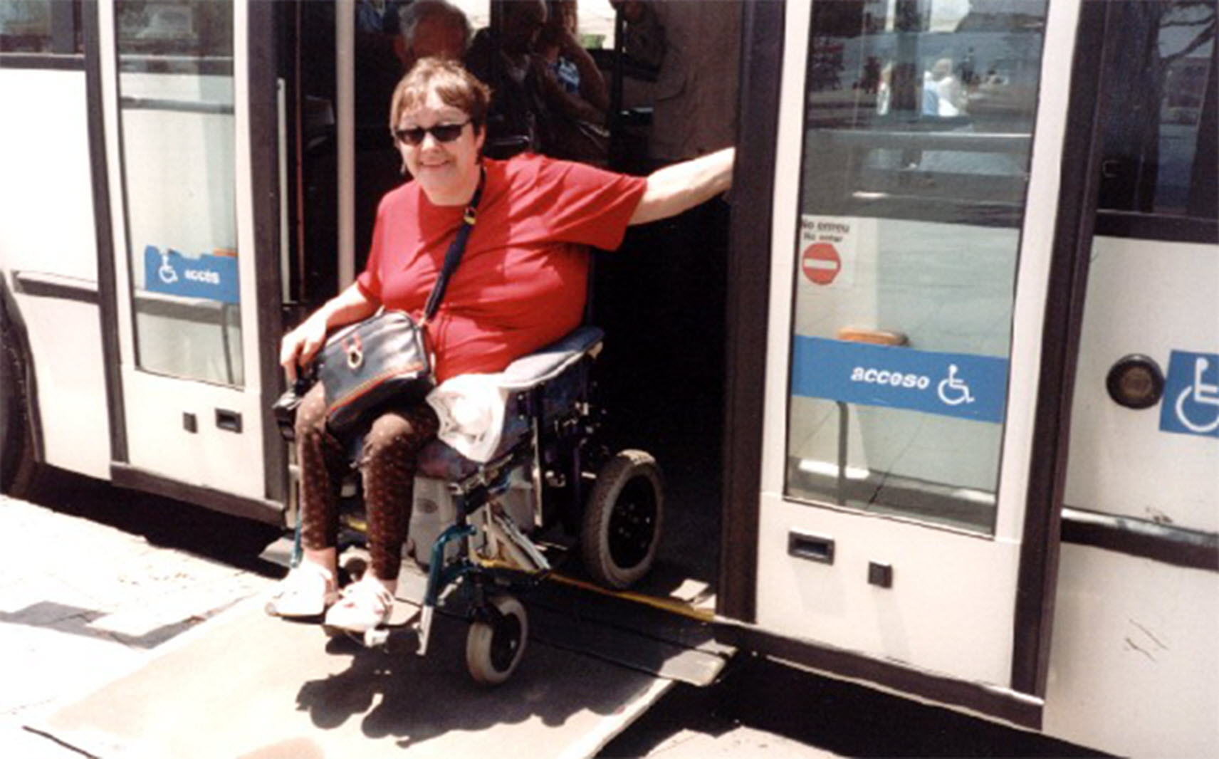wheelchair user exits a train